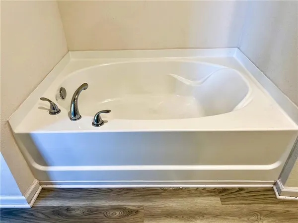 a bedroom with a bed and a television