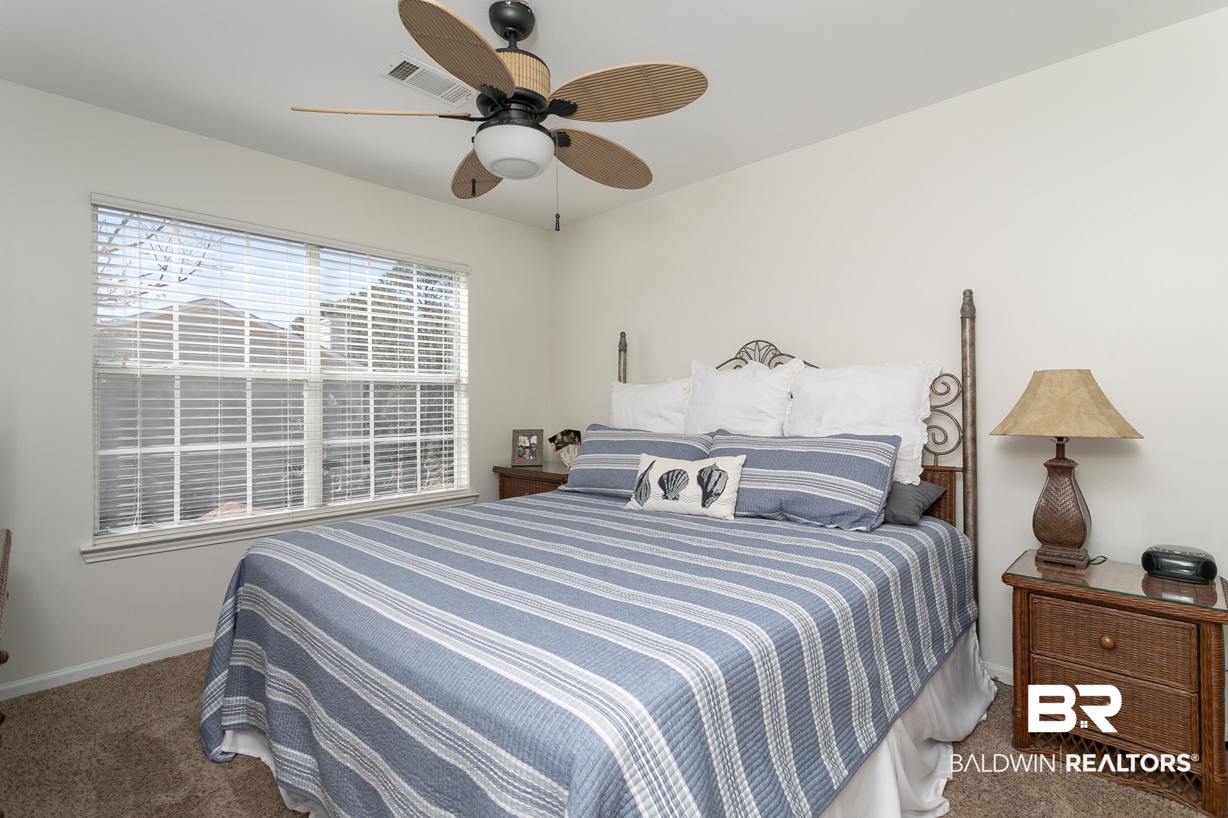 1517 Regency Road, Unit 33 Gulf Shores, AL 36542 - Photo 14 of 29 Bedroom with visible vents, baseboards, carpet, and ceiling fan