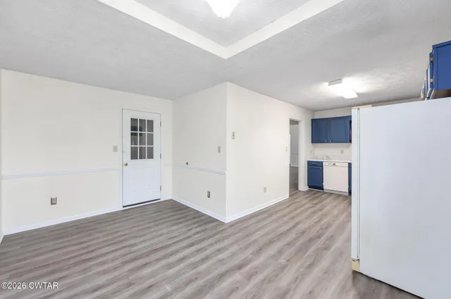 a view of a kitchen with wooden floor