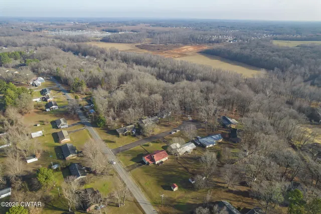 a view of a house with a yard covered in snow