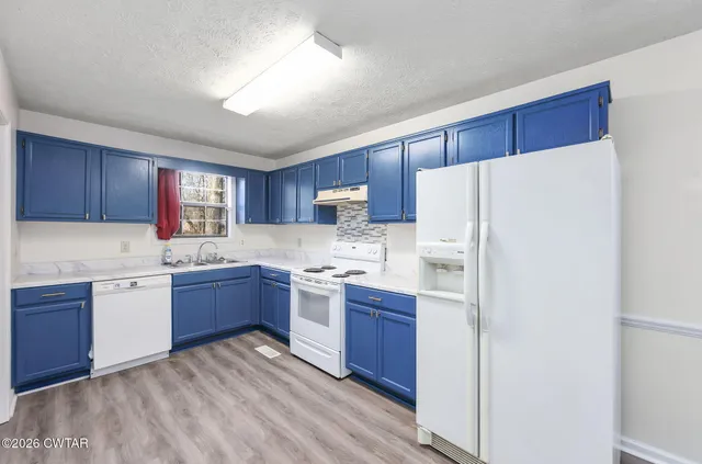 a kitchen with sink a stove and refrigerator