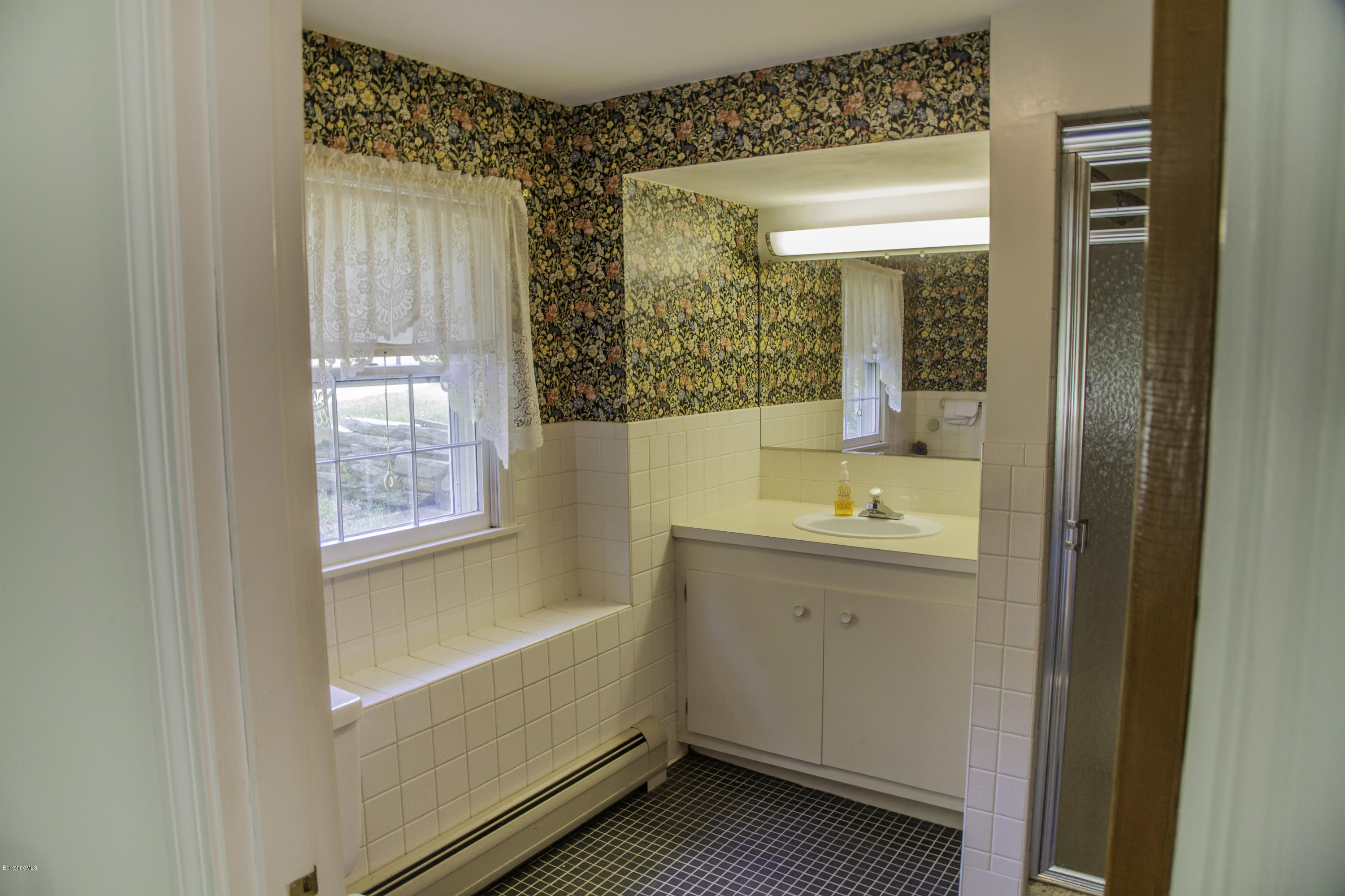 375 Devon Road Lee, MA 01238 - Photo 17 of 23 a bathroom with a tub sink and mirror