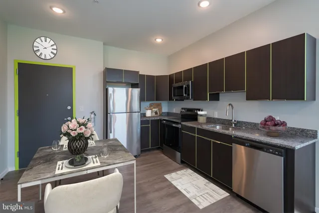 a kitchen with a refrigerator sink cabinets and a stove