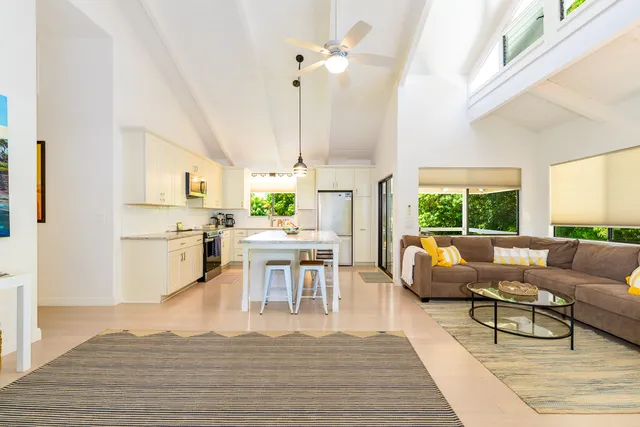 a living room with furniture fireplace and a large window