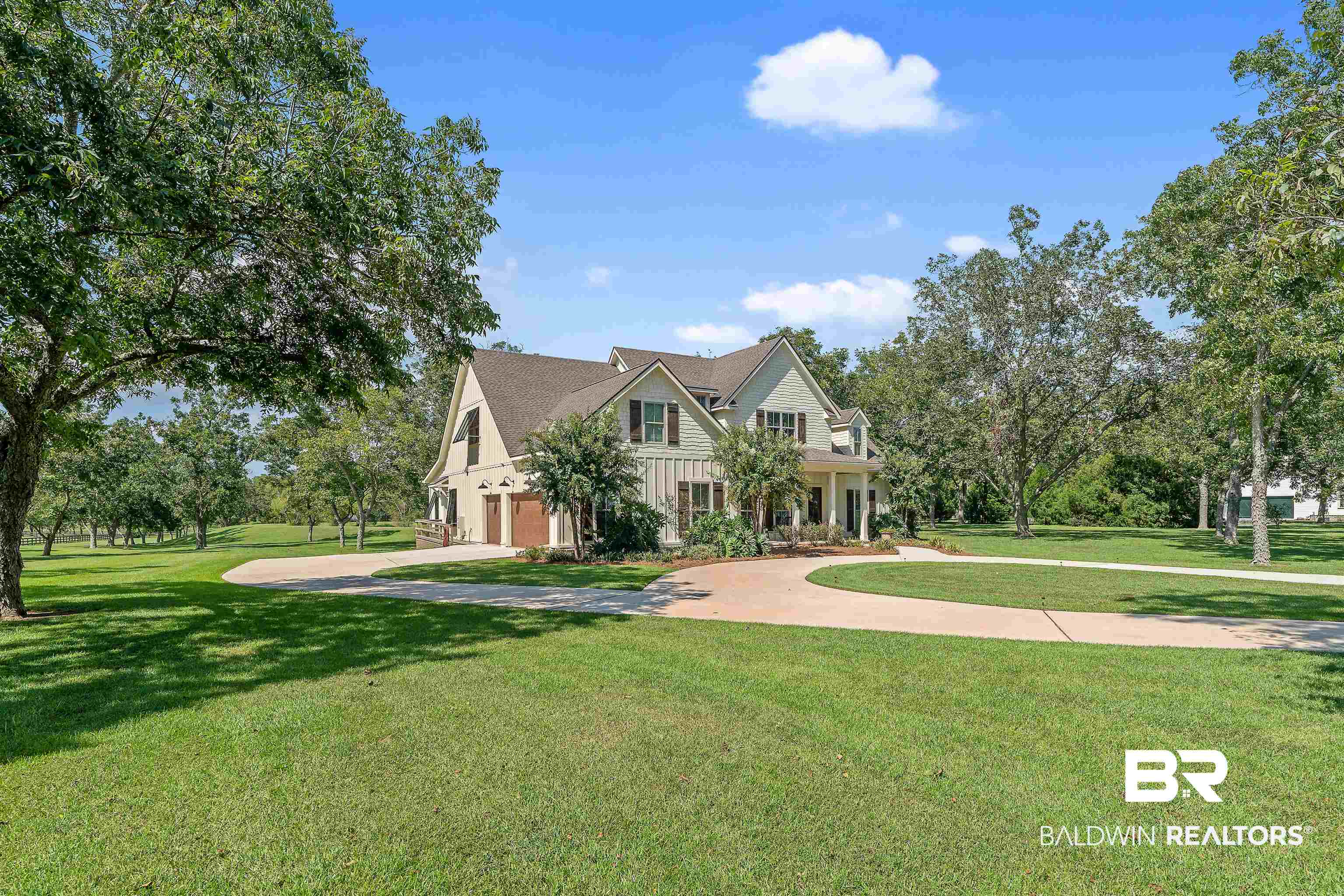8753 Bishop Road Fairhope, AL 36532 - Photo 5 of 59 Expansive manicured lawn surrounding a residence featuring light-toned siding, dark shutters, and a covered porch
