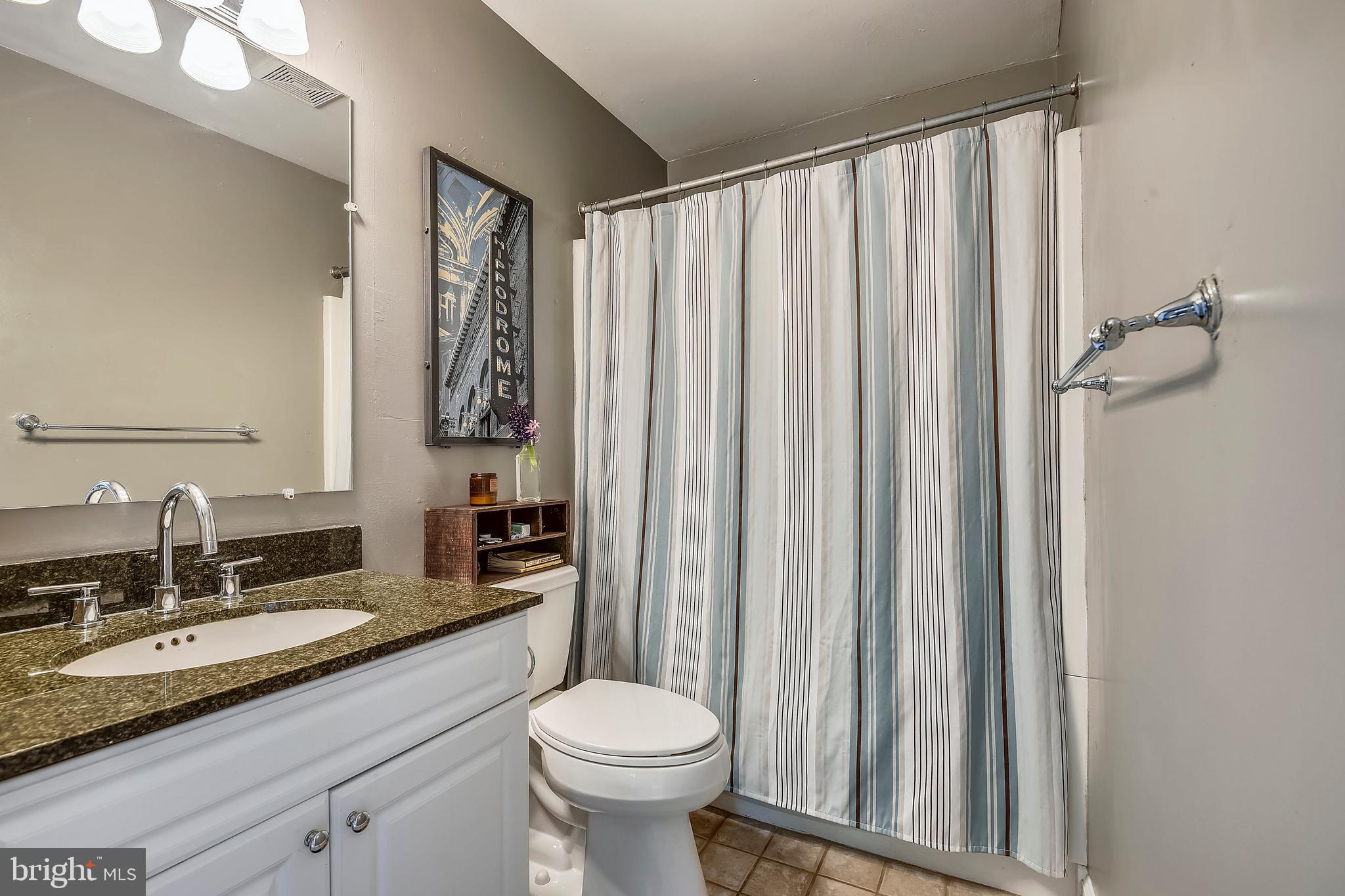 19933 Middletown Road Freeland, MD 21053 - Photo 11 of 36 a bathroom with a granite countertop sink toilet and mirror