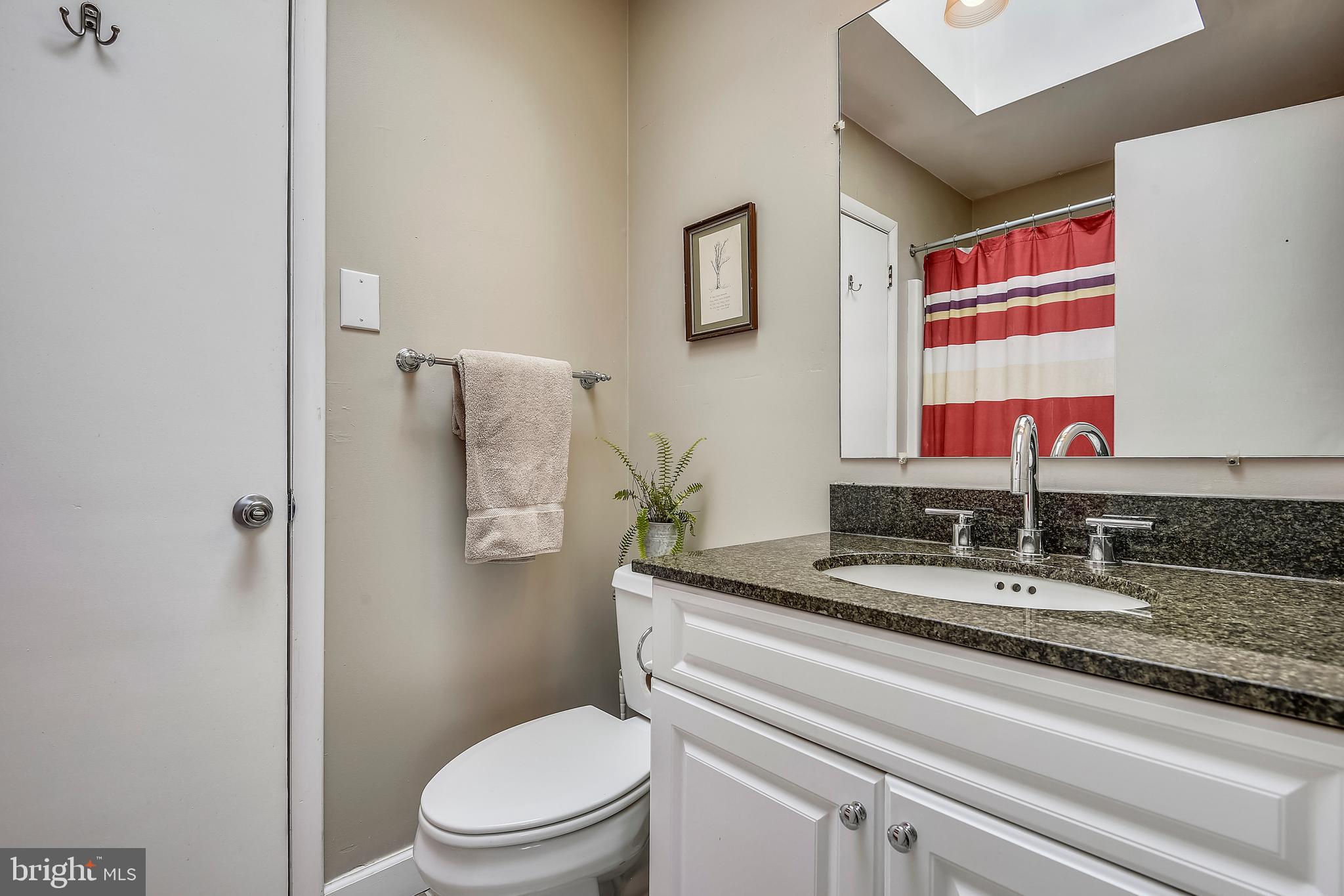19933 Middletown Road Freeland, MD 21053 - Photo 16 of 36 a bathroom with a granite countertop toilet sink and mirror