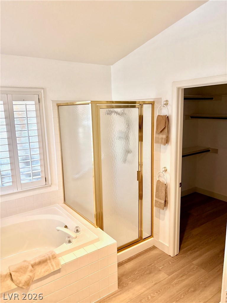 9040 Dove River Road Las Vegas, NV 89134 - Photo 14 of 22 An inviting soaking tub pairs with a glass-enclosed shower in this comfortable layout.