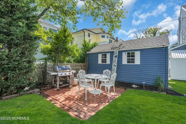 a view of a house with a backyard and chairs