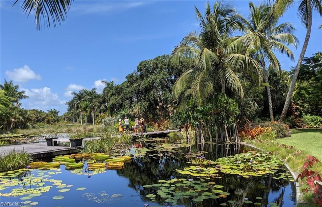0 Bayshore Drive Naples, FL 34112 - Photo 10 of 18 a view of a yard with lawn chairs under an umbrella