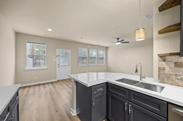 a spacious bathroom with a sink and a window
