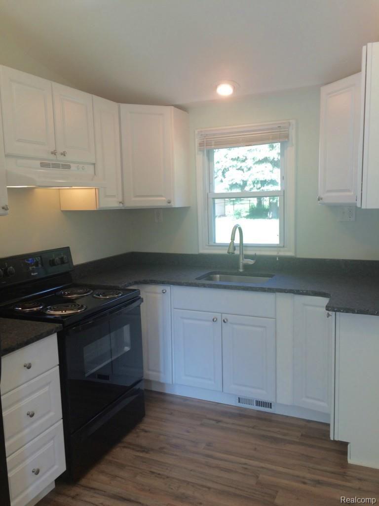 47435 Greenview Road Utica, MI 48317 - Photo 3 of 11 WHITE KITCHEN CABINETS, GRANITE COUNTERS IN HONED FINISH WITH ROUGH CUT EDGES