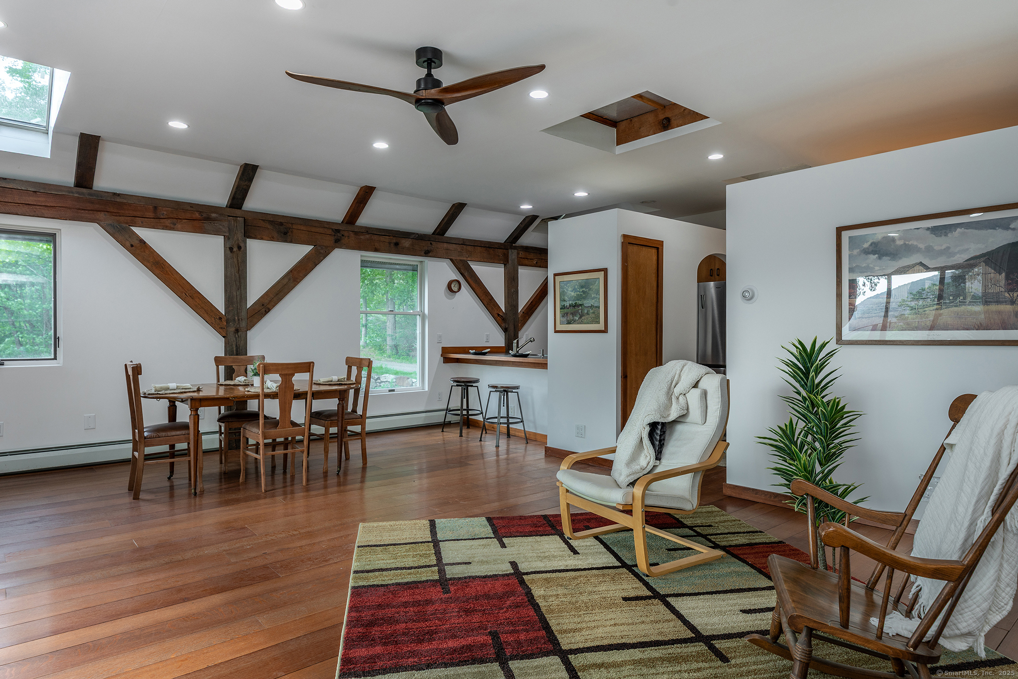 178 Carter Road Kent, CT 06754 - Photo 17 of 37 a dining room with wooden floor a glass table and chairs