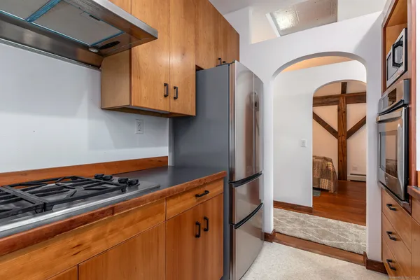 a kitchen with stainless steel appliances granite countertop a refrigerator and a stove