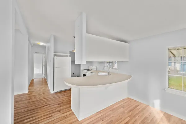a spacious bathroom with a sink and a mirror