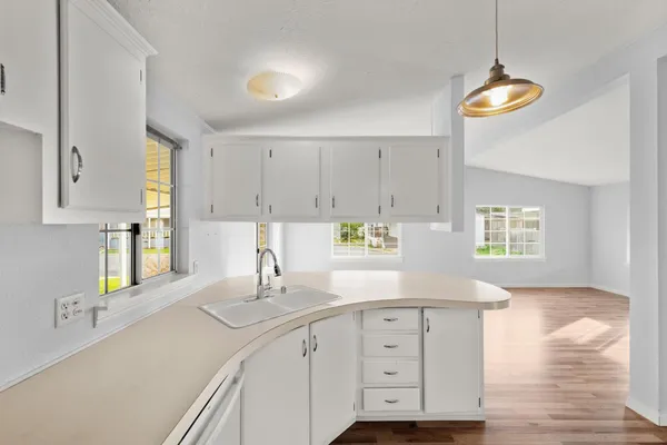 a kitchen with cabinets and window