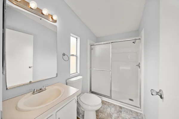 a bathroom with a sink toilet and shower