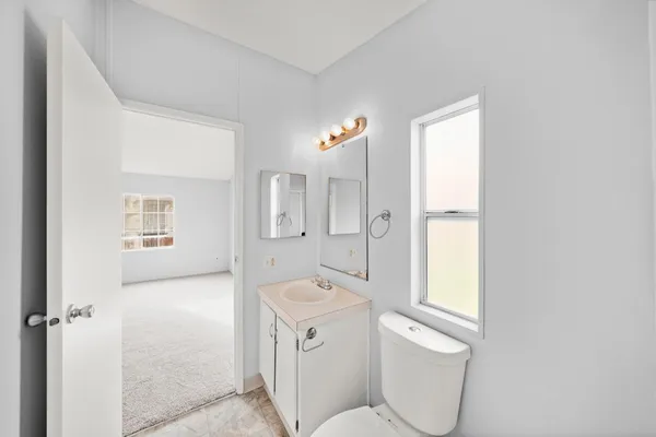 a bathroom with a toilet sink and mirror