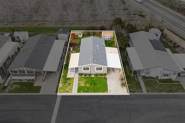an aerial view of a house with a yard