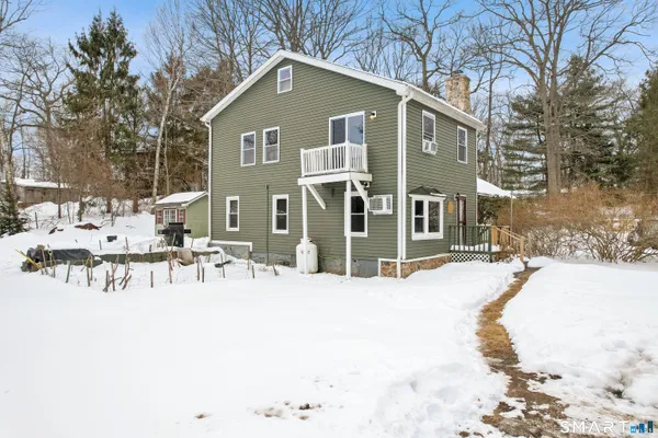 a view of a house with a yard covered in snow