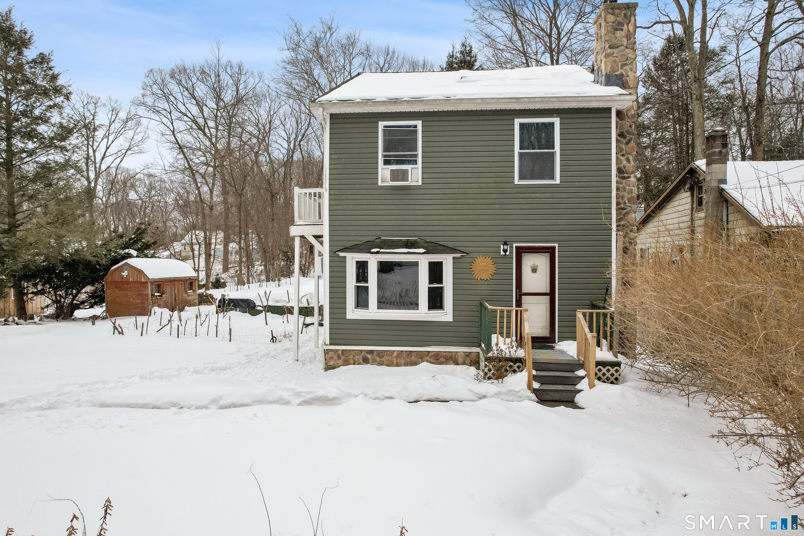 a view of a house with a yard covered in snow