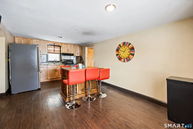 a room with furniture and a kitchen view