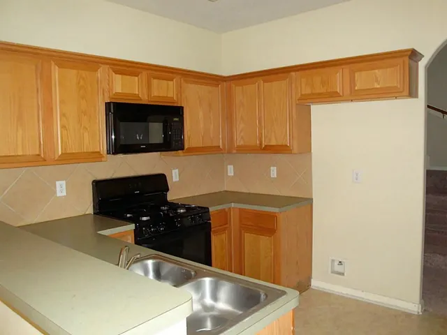 a kitchen with a sink and a microwave