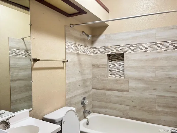 a bathroom with a bathtub and shower