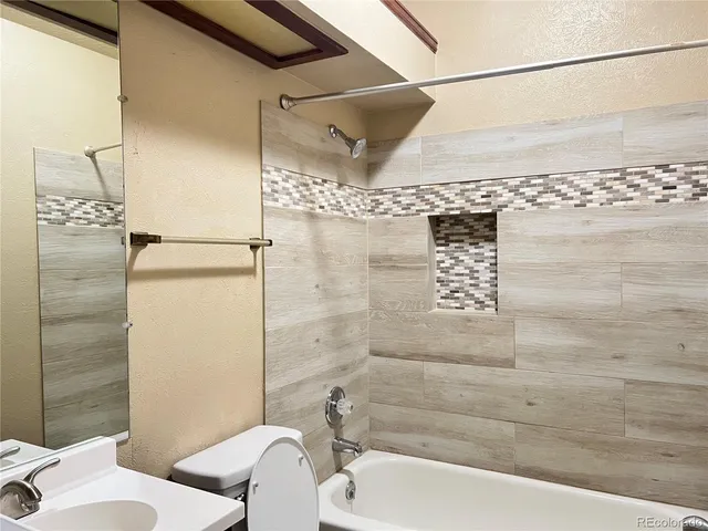 a bathroom with a bathtub and shower