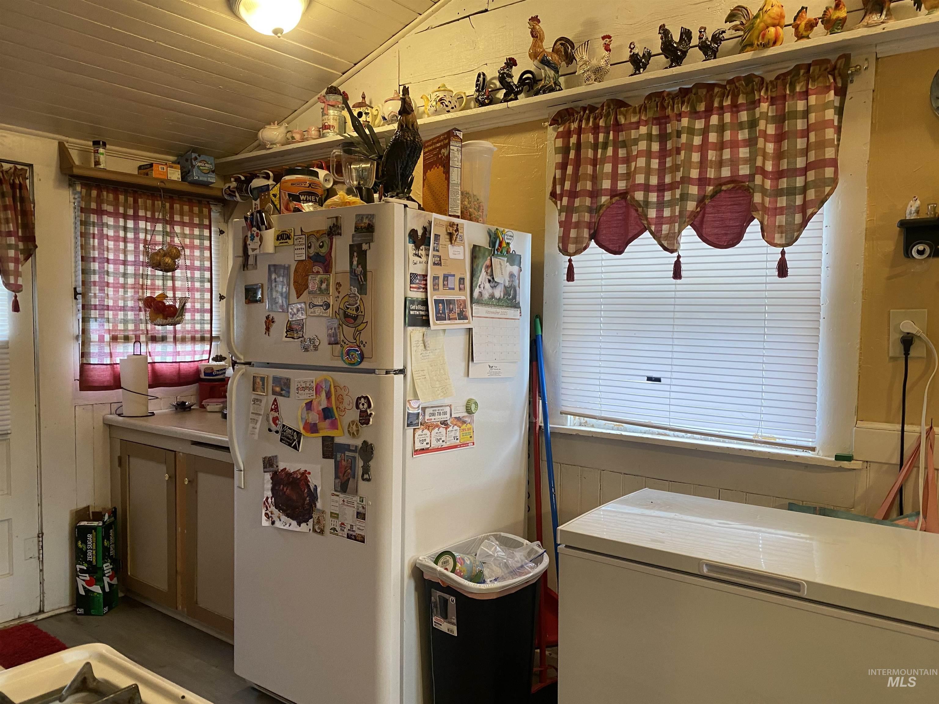 502 East Court Street Weiser, ID 83672 - Photo 6 of 17 Kitchen featuring freestanding refrigerator, vaulted ceiling, healthy amount of natural light, and wooden ceiling