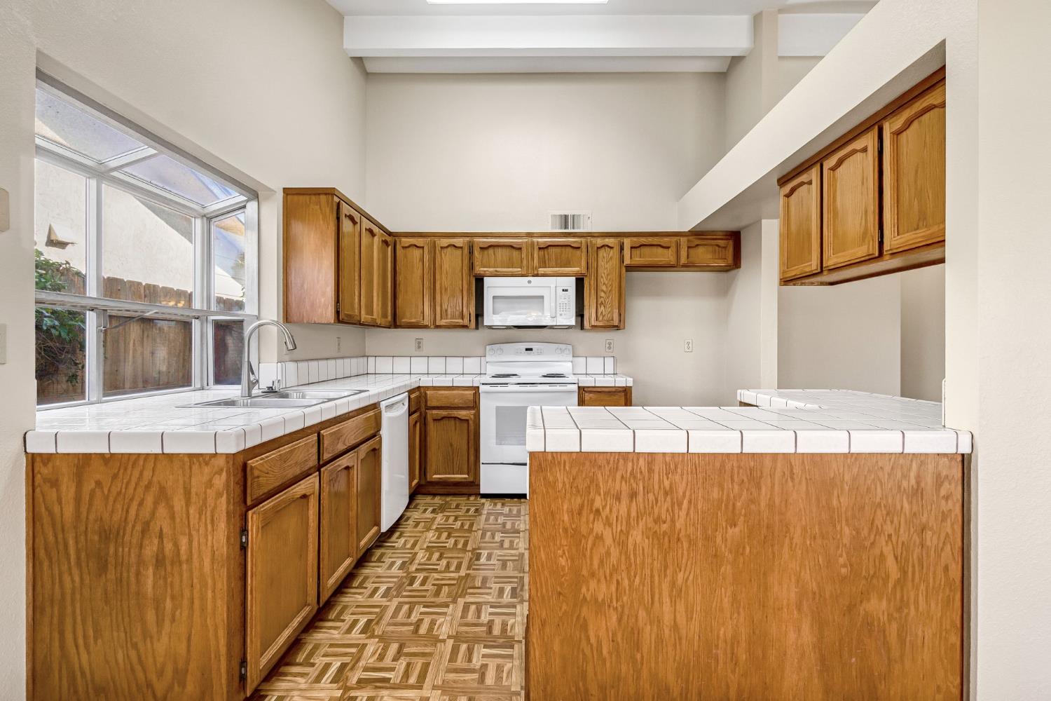 3837 North State Street Fresno, CA 93722 - Photo 15 of 33 a kitchen with stainless steel appliances granite countertop a sink stove and a refrigerator
