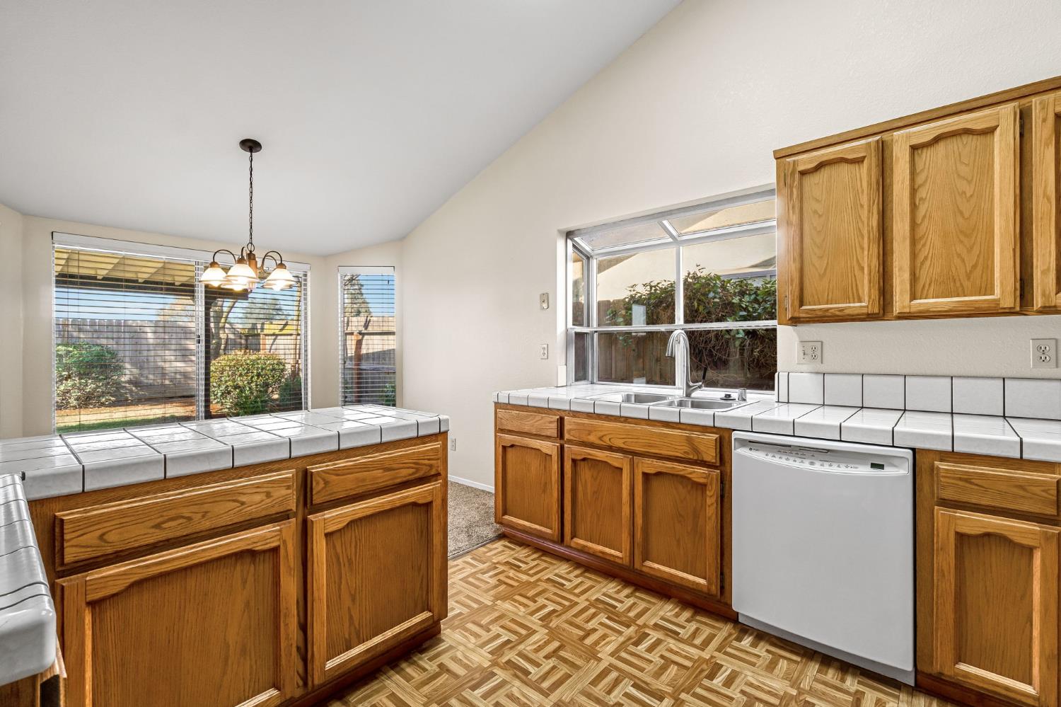 3837 North State Street Fresno, CA 93722 - Photo 17 of 33 a kitchen with stainless steel appliances granite countertop a stove a sink and a refrigerator