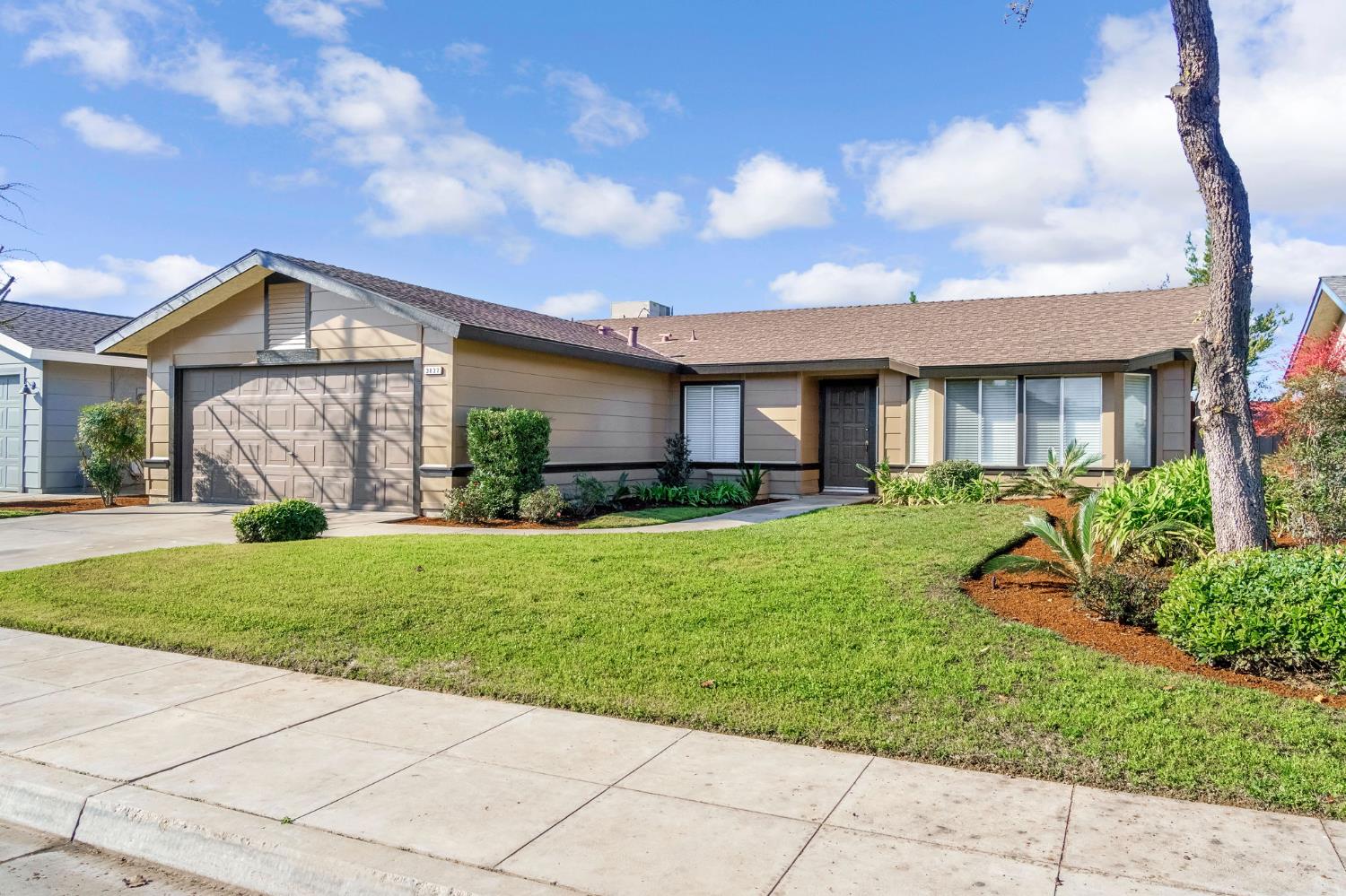 3837 North State Street Fresno, CA 93722 - Photo 2 of 33 a front view of a house with a yard