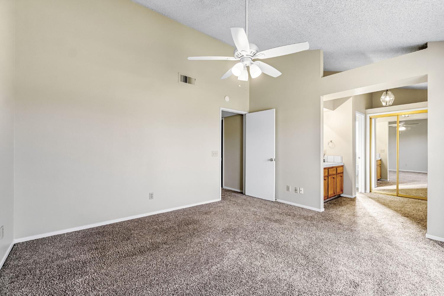 3837 North State Street Fresno, CA 93722 - Photo 27 of 33 an empty room with closet and a chandelier fan