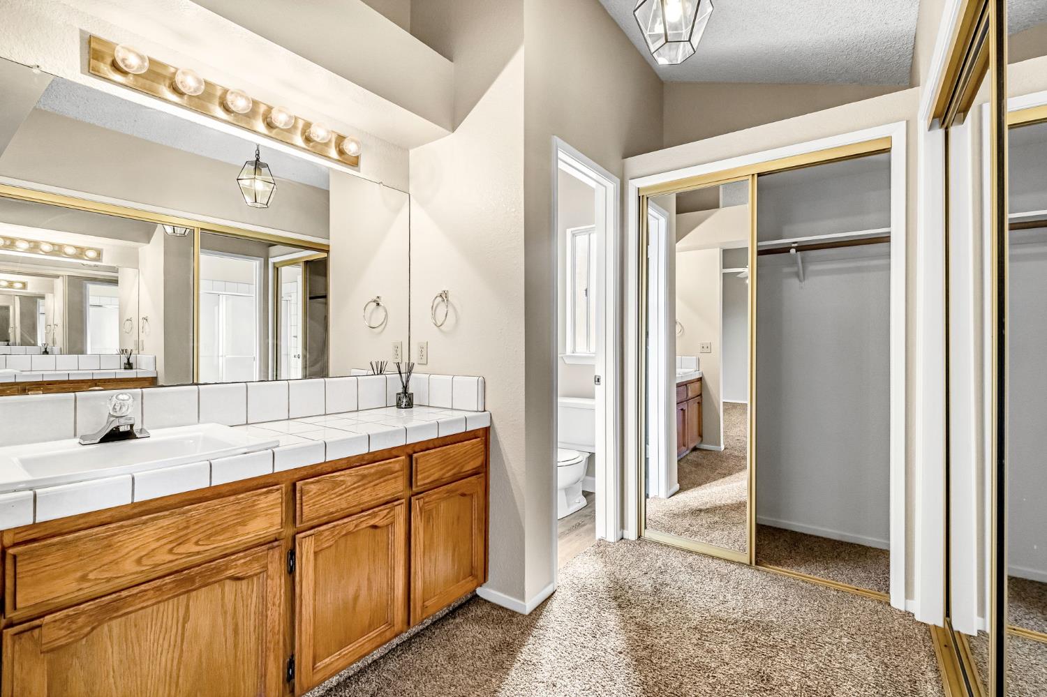 3837 North State Street Fresno, CA 93722 - Photo 28 of 33 a spacious bathroom with a double vanity sink and a mirror