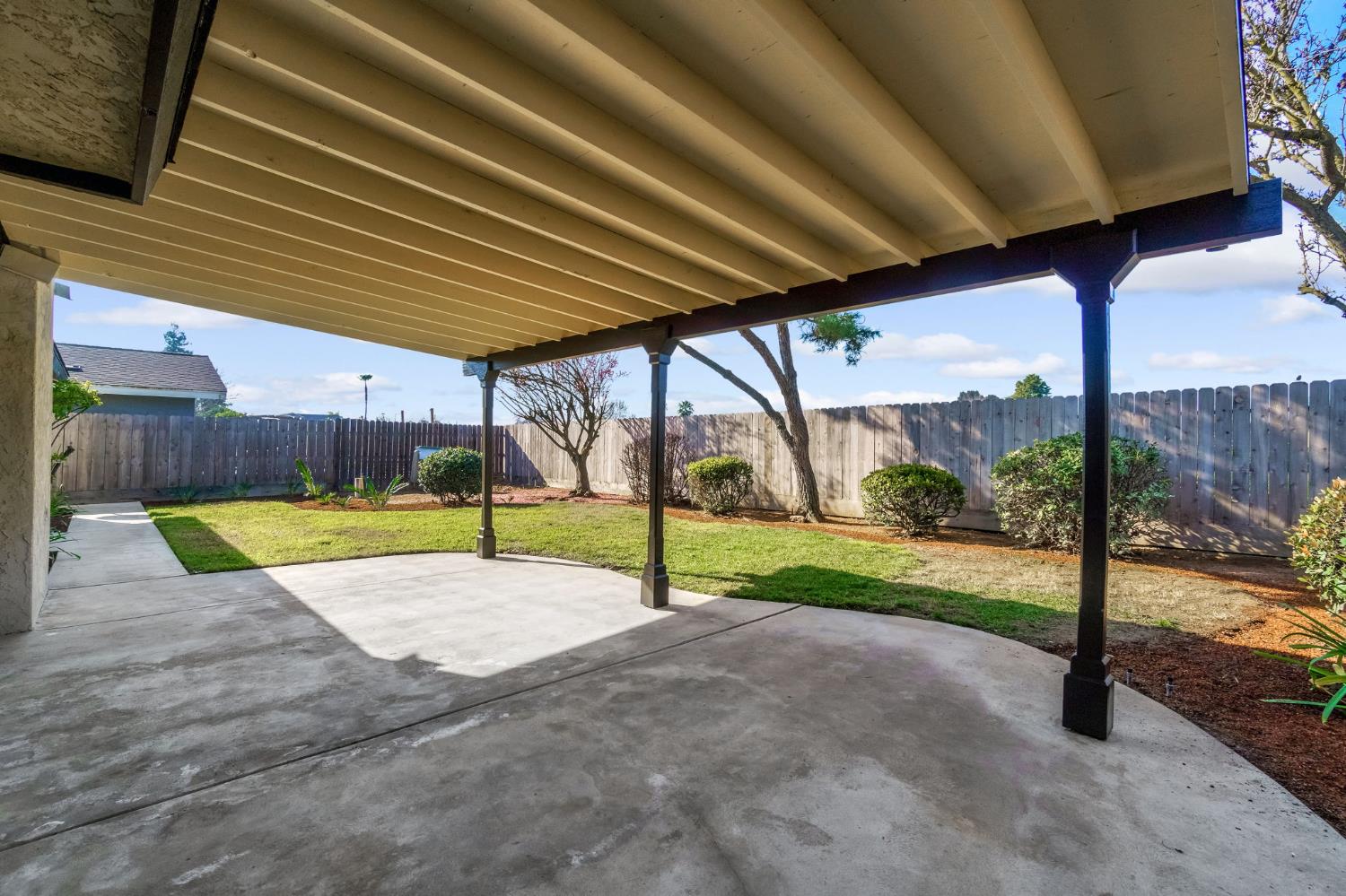3837 North State Street Fresno, CA 93722 - Photo 30 of 33 a view of a backyard with wooden fence