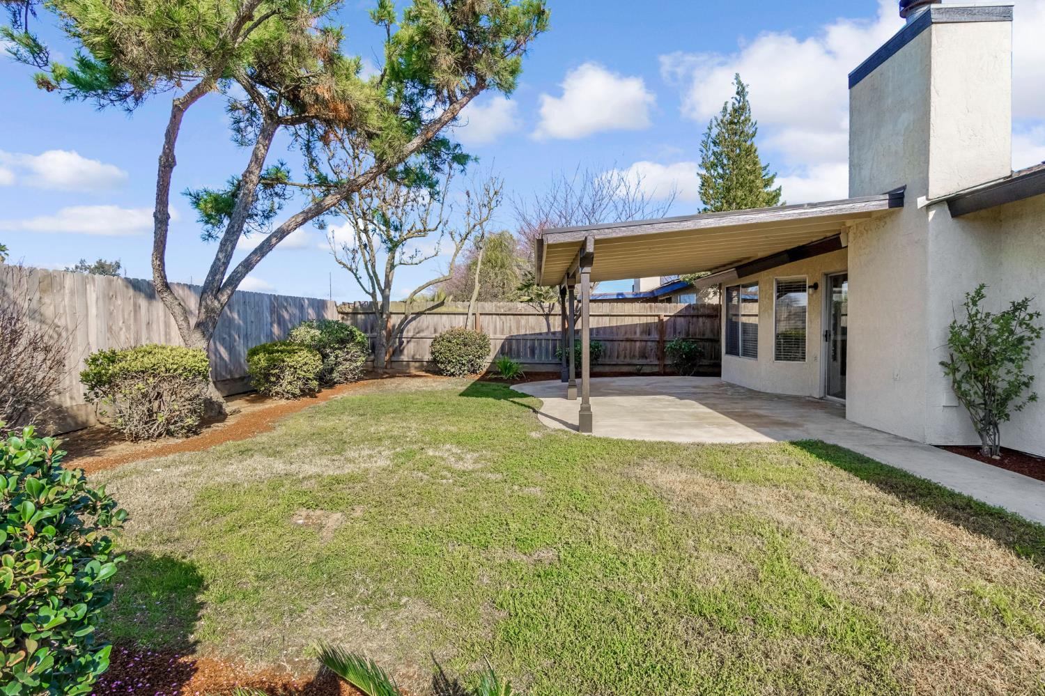 3837 North State Street Fresno, CA 93722 - Photo 33 of 33 a view of a house with a yard and potted plants