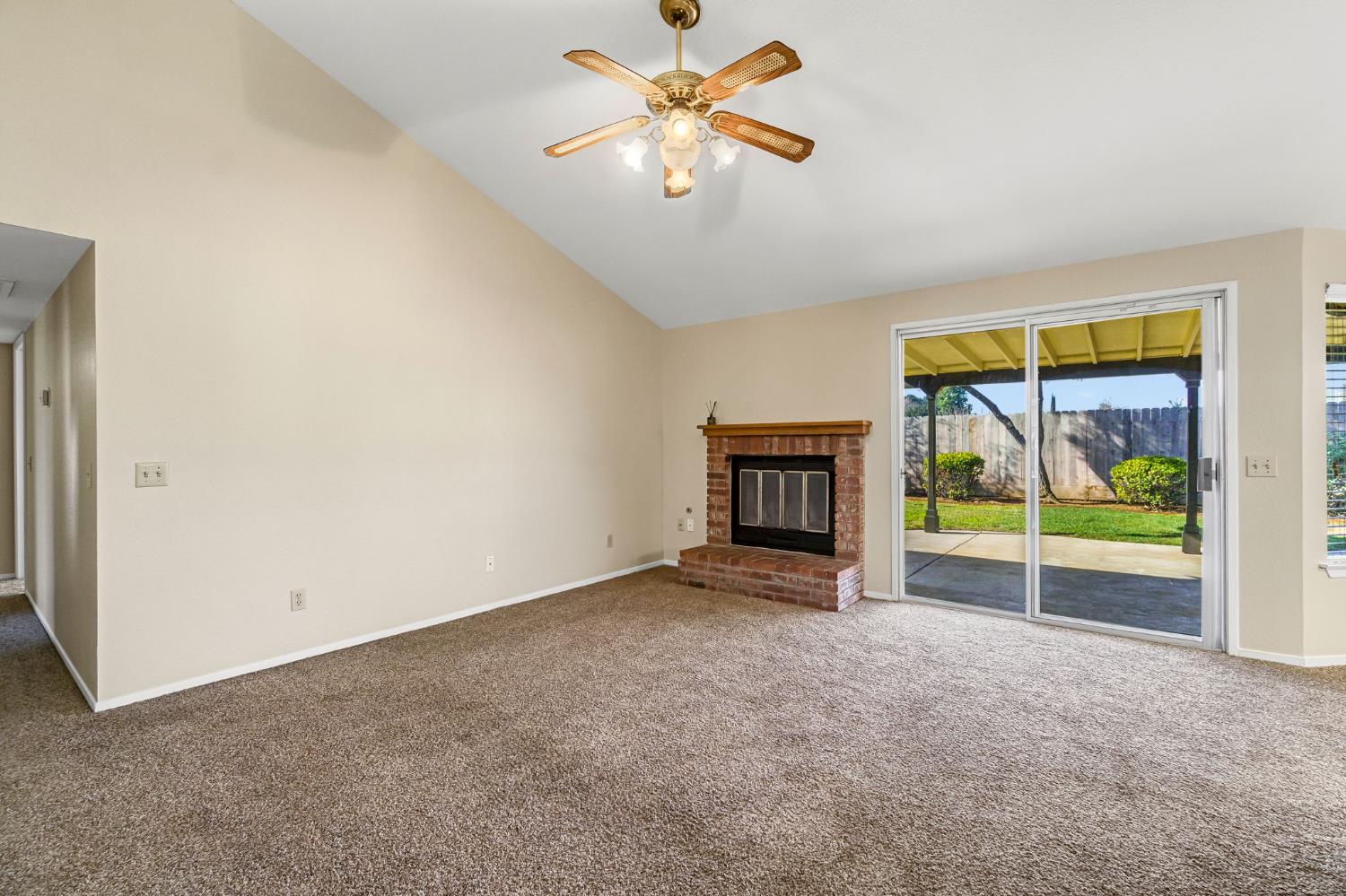 3837 North State Street Fresno, CA 93722 - Photo 10 of 33 an empty room with fireplace and fan
