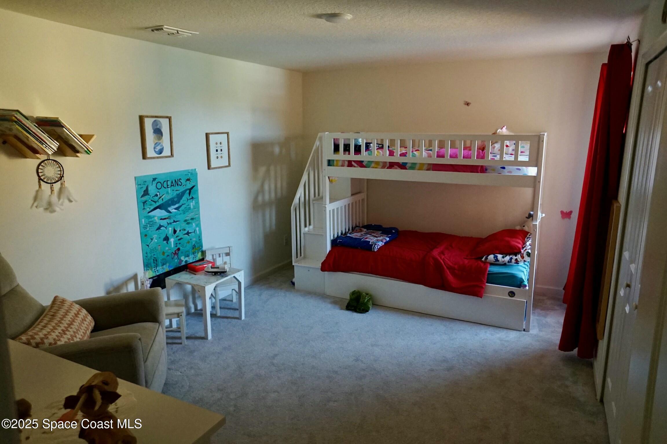95 Montecito Drive Satellite Beach, FL 32937 - Photo 11 of 20 a bedroom with furniture and a bed