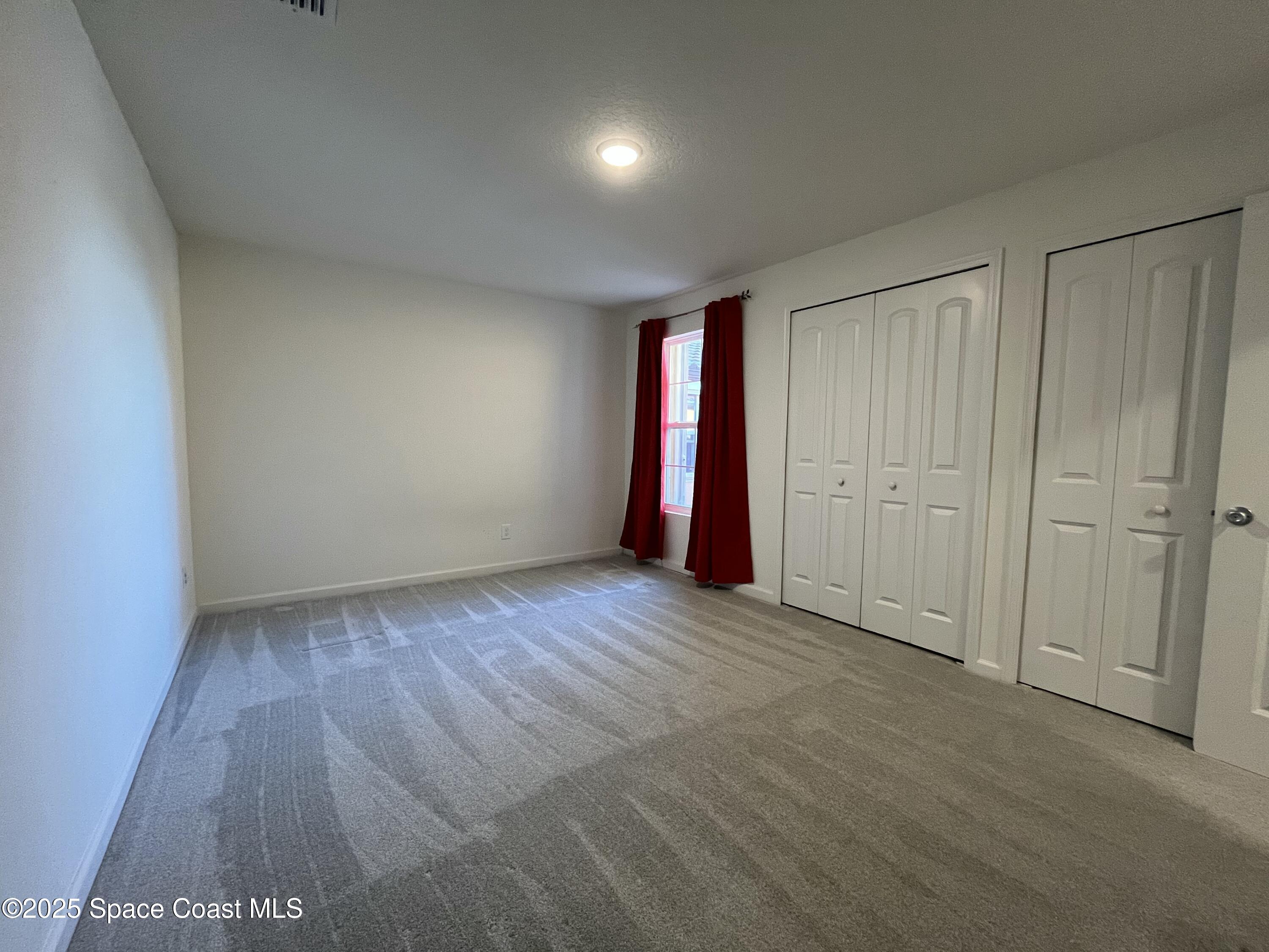 95 Montecito Drive Satellite Beach, FL 32937 - Photo 12 of 20 a view of an empty room with wooden floor