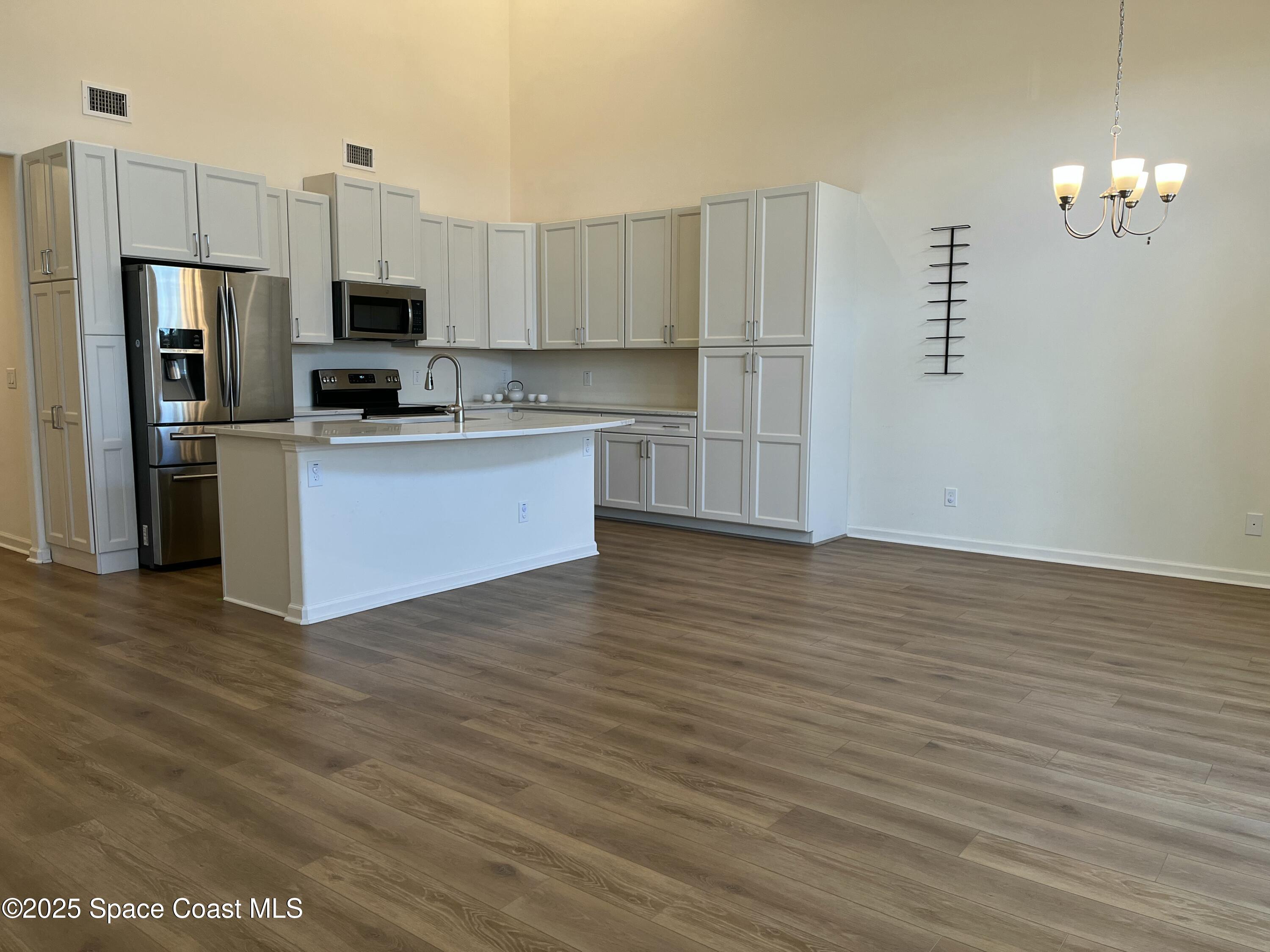 95 Montecito Drive Satellite Beach, FL 32937 - Photo 14 of 20 a kitchen with stainless steel appliances a refrigerator and a stove top oven