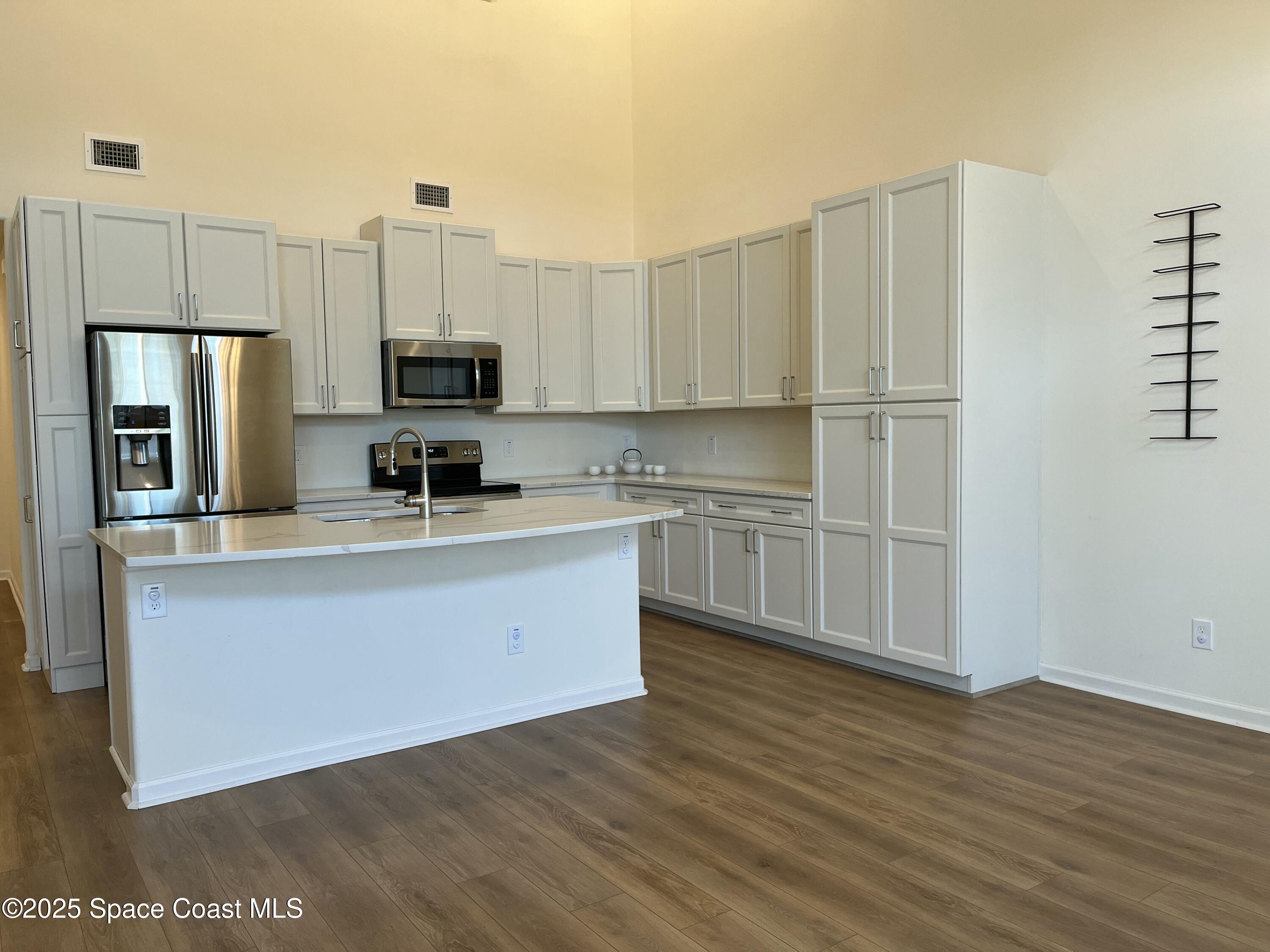 95 Montecito Drive Satellite Beach, FL 32937 - Photo 15 of 20 a kitchen with stainless steel appliances a refrigerator sink and microwave