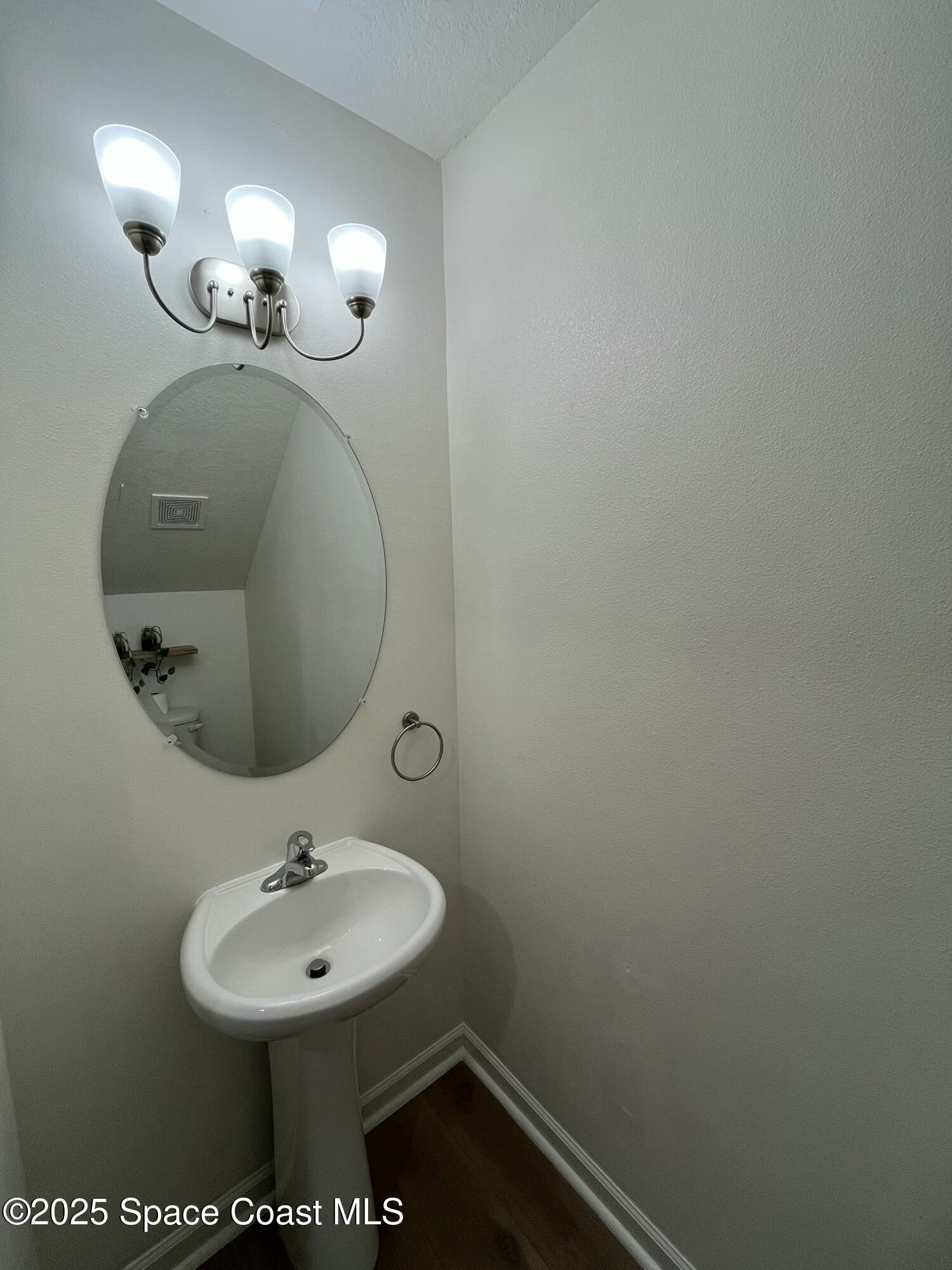 95 Montecito Drive Satellite Beach, FL 32937 - Photo 16 of 20 a bathroom with a sink and a mirror