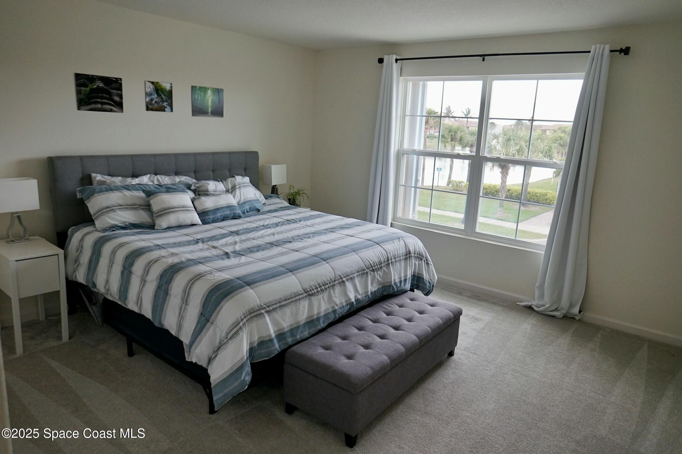 95 Montecito Drive Satellite Beach, FL 32937 - Photo 9 of 20 a bedroom with a bed and a window