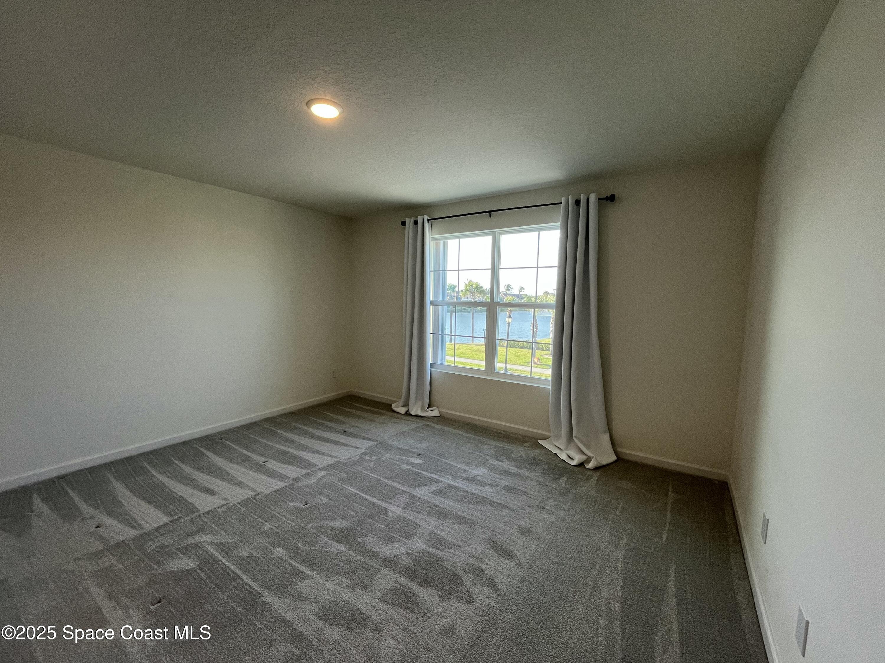 95 Montecito Drive Satellite Beach, FL 32937 - Photo 10 of 20 an empty room with windows