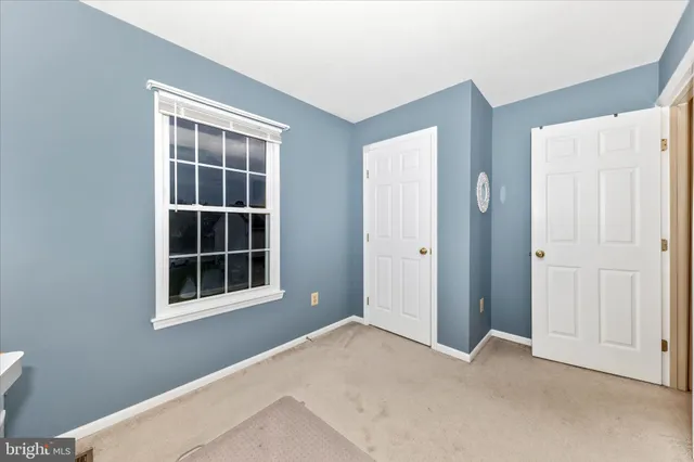 a view of empty room with windows and entryway