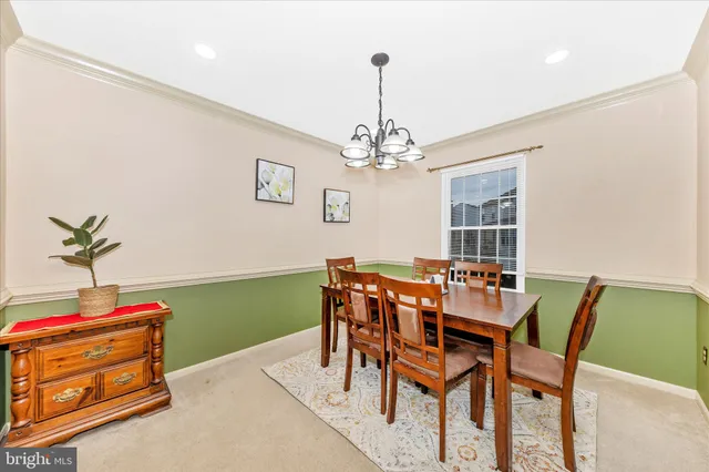 a view of a dining room with furniture and chandelier