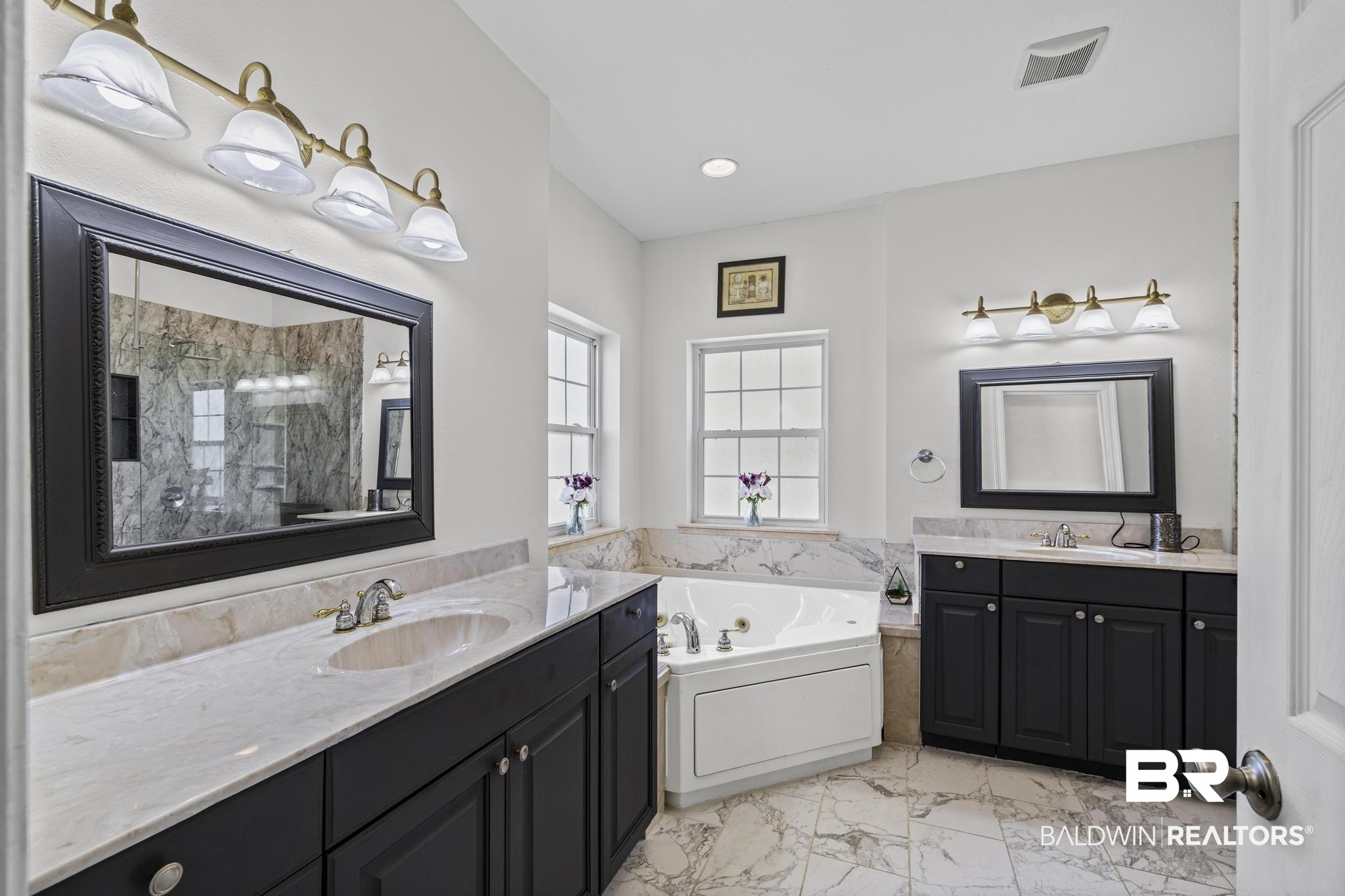 32875 Faircloth Road Lillian, AL 36549 - Photo 39 of 85 Full bath featuring two vanities, a jetted tub, a marble finish shower, light marble finish flooring, and recessed lighting