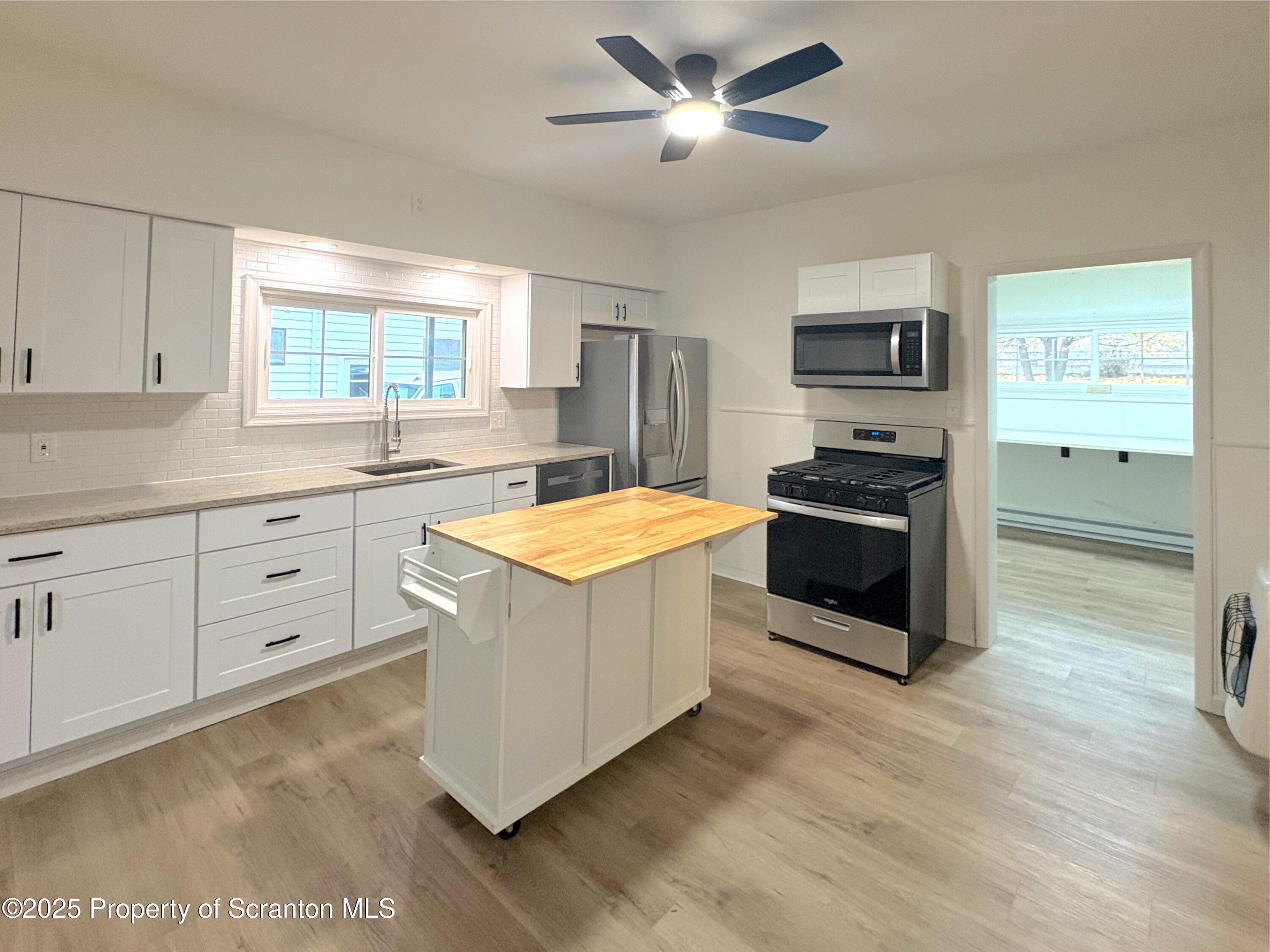 115 West Warren Street Dunmore, PA 18512 - Photo 2 of 36 a kitchen with white cabinets and appliances