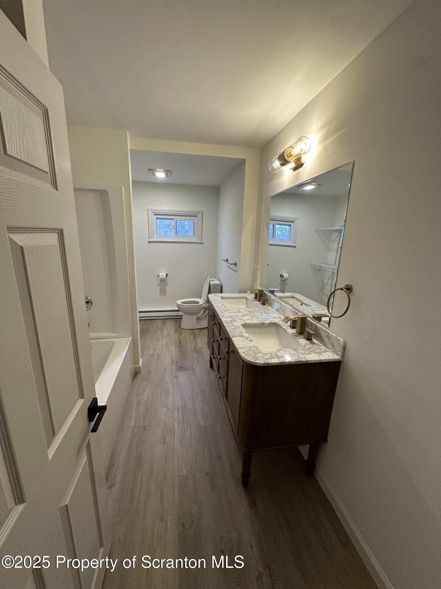 115 West Warren Street Dunmore, PA 18512 - Photo 21 of 36 a bathroom with a sink a mirror and a toilet